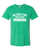 HE SEES YOU WHEN YOU'RE DRINKING BOUTIQUE TEE